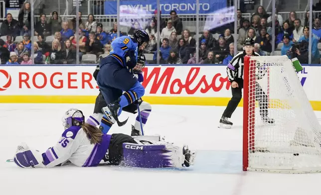 Toronto Sceptres' Daryl Watts (9) scores on Minnesota Frost goaltender Maddie Rooney (35) as Frost's Claire Thompson (42) defends during the second period of a PWHL hockey game, Saturday, Dec. 7, 2024. (Chris Young/The Canadian Press via AP)