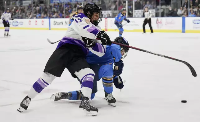Minnesota Frost's Brooke Bryant (17) battles for the puck with Toronto Sceptres' Jocelyne Larocque during the third period of a PWHL hockey game, Saturday, Dec. 7, 2024. (Chris Young/The Canadian Press via AP)