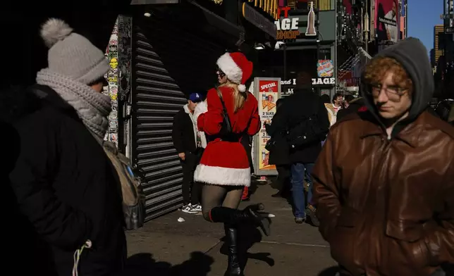 A reveller takes part in SantaCon, Saturday, Dec. 14, 2024, in New York. (AP Photo/Julia Demaree Nikhinson)