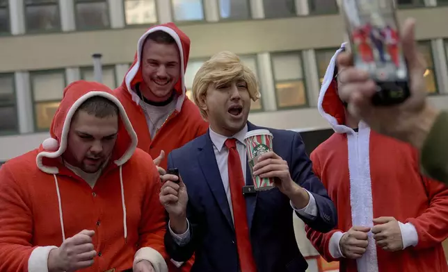 Revellers take part in SantaCon, Saturday, Dec. 14, 2024, in New York. (AP Photo/Julia Demaree Nikhinson)