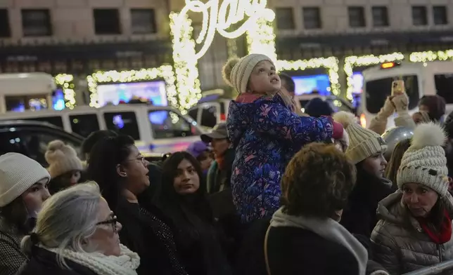 People arrive for the 92nd annual Rockefeller Center Christmas tree lighting ceremony, Wednesday, Dec. 4, 2024, in New York. (AP Photo/Julia Demaree Nikhinson)