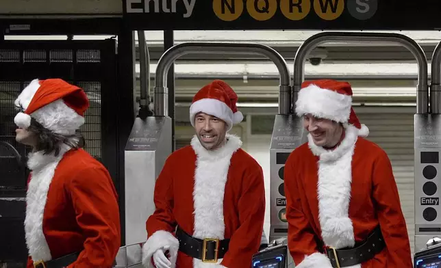 Revellers arrive for SantaCon via subway, Saturday, Dec. 14, 2024, in New York. (AP Photo/Julia Demaree Nikhinson)