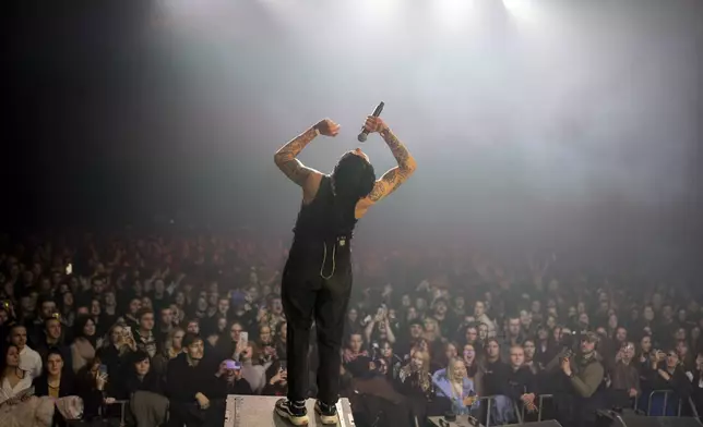 Dmytro Odnorozhenko, solo singer of punk rock band Hatespeech sings during the presentation of the music album Epoch, a collaboration between Ukrainian artists and the 3rd Assault Brigade, in Kyiv, Ukraine, Saturday, Dec. 7, 2024. (AP Photo/Alex Babenko)