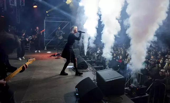 Indie rock band Renie Cares performs during the presentation of the music album Epoch, a collaboration between Ukrainian artists and the 3rd Assault Brigade, in Kyiv, Ukraine, Saturday, Dec. 7, 2024. (AP Photo/Alex Babenko)