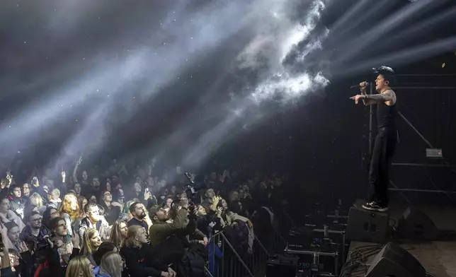 Dmytro Odnorozhenko, solo singer of punk rock band Hatespeech sings during the presentation of the music album Epoch, a collaboration between Ukrainian artists and the 3rd Assault Brigade, in Kyiv, Ukraine, Saturday, Dec. 7, 2024. (AP Photo/Alex Babenko)