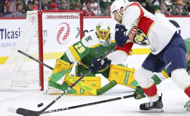 Minnesota Wild goaltender Marc-Andre Fleury (29) defends his net against Florida Panthers center Sam Reinhart (13) during the second period of an NHL hockey game Wednesday, Dec. 18, 2024, in St. Paul, Minn. (AP Photo/Matt Krohn)