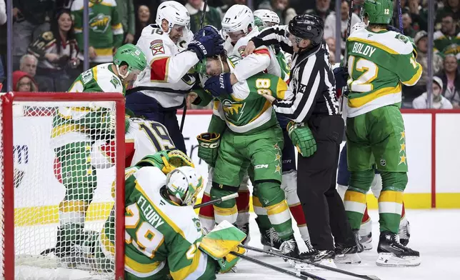 Minnesota Wild and Florida Panthers players get into a scrum after Panthers left wing Matthew Tkachuk's (19) goal during the second period of an NHL hockey game Wednesday, Dec. 18, 2024, in St. Paul, Minn. (AP Photo/Matt Krohn)