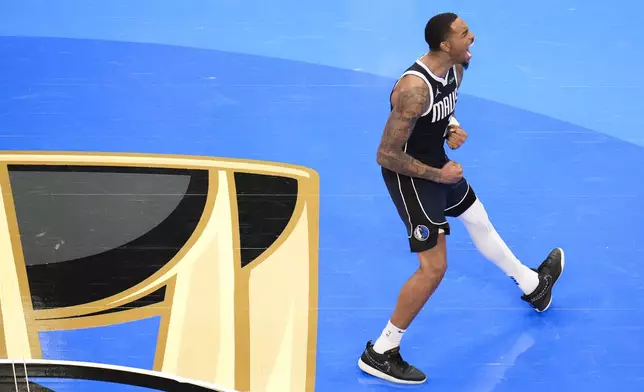 Dallas Mavericks forward P.J. Washington reacts after scoring a basket against the Memphis Grizzlies during the second half of an Emirates NBA Cup basketball game, Tuesday, Dec. 3, 2024, in Dallas. The Mavericks won 121-116. (AP Photo/Julio Cortez)