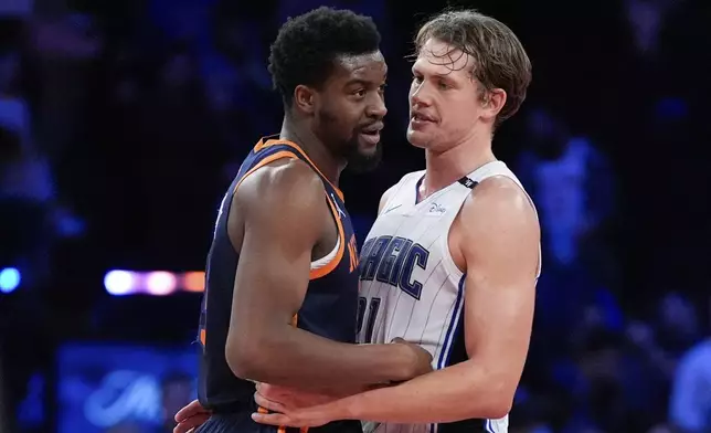 New York Knicks center Ariel Hukporti, left, and Orlando Magic center Moritz Wagner, right, hug following the second half of an NBA Cup basketball game, Tuesday, Dec. 3, 2024, in New York, N.Y. The Knicks won 121-106. (AP Photo/Julia Demaree Nikhinson)