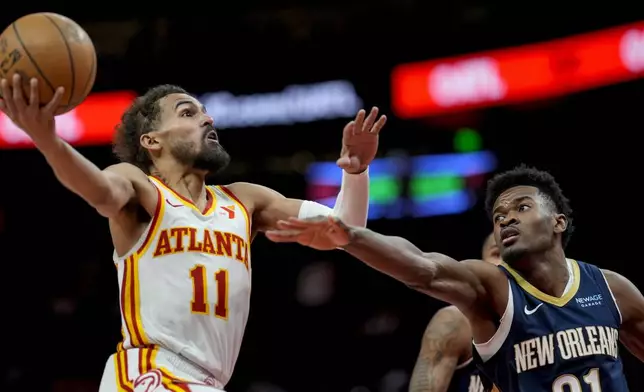 Atlanta Hawks guard Trae Young (11) shoots against New Orleans Pelicans center Yves Missi (21) during the second half of an NBA basketball game, Monday, Dec. 2, 2024, in Atlanta. (AP Photo/Mike Stewart)