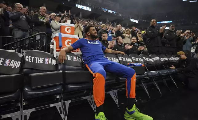 New York Knicks center Karl-Anthony Towns watches as a tribute video is played honoring his time playing for the Minnesota Timberwolves before an NBA basketball game, Thursday, Dec. 19, 2024, in Minneapolis. (AP Photo/Abbie Parr)