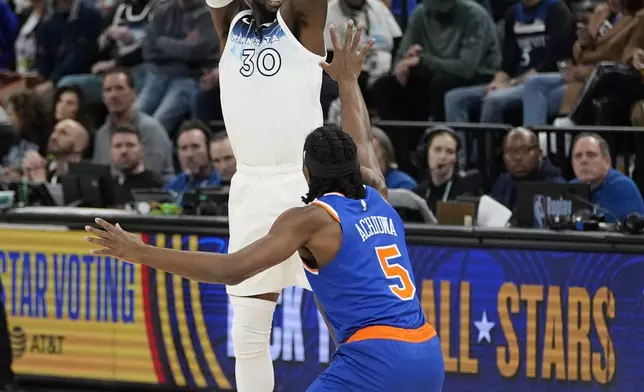 Minnesota Timberwolves forward Julius Randle (30) shoots over New York Knicks forward Precious Achiuwa (5) during the first half of an NBA basketball game, Thursday, Dec. 19, 2024, in Minneapolis. (AP Photo/Abbie Parr)