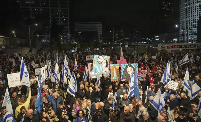 Israelis protest against Prime Minister Benjamin Netanyahu's government and call for the release of hostages held in the Gaza Strip by the Hamas militant group, in Tel Aviv, Israel, Saturday, Dec. 28, 2024. (AP Photo/Ariel Schalit)