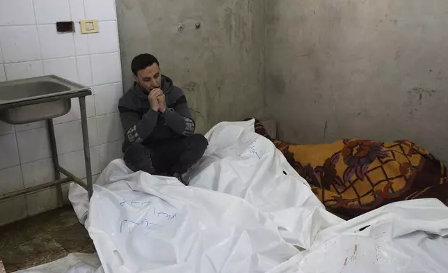 A Palestinian man sits mourning relatives killed in overnight Israeli airstrikes on the Maghazi refugee camp, at Al-Aqsa Hospital, in Deir al-Balah, central Gaza Strip, Saturday, Dec. 28, 2024. (AP Photo/Abdel Kareem Hana)