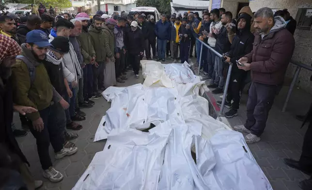 Palestinians attend funeral prayers over the bodies of those killed in overnight Israeli airstrikes on the Maghazi refugee camp, at Al-Aqsa Hospital, in Deir al-Balah, central Gaza Strip, Saturday, Dec. 28, 2024. (AP Photo/Abdel Kareem Hana)