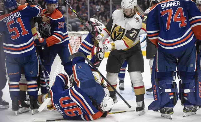 Vegas Golden Knights and Edmonton Oilers rough it up during the third period of an NHL game in Edmonton, Alberta, Saturday, Dec. 14, 2024. (Jason Franson/The Canadian Press via AP)