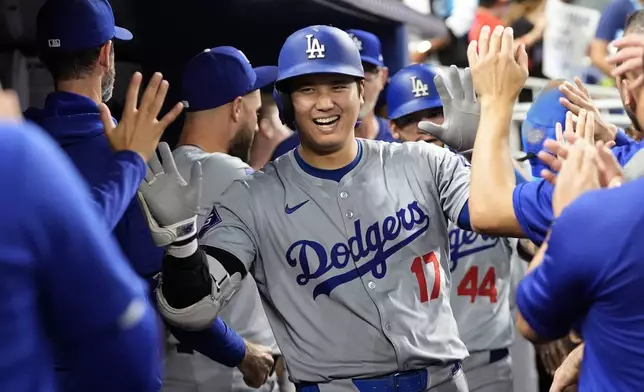 FILE - Los Angeles Dodgers' Shohei Ohtani (17) celebrates in the dugout after hitting a home run during the sixth inning of a baseball game against the Miami Marlins, Thursday, Sept. 19, 2024, in Miami. (AP Photo/Marta Lavandier, File)