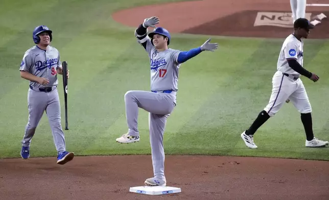 FILE - Los Angeles Dodgers' Shohei Ohtani (17) of Japan, celebrates after hitting a double during the first inning of a baseball game against the Miami Marlins, Thursday, Sept. 19, 2024, in Miami. (AP Photo/Wilfredo Lee, File)