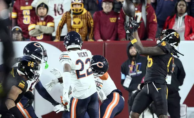 FILE - Washington Commanders wide receiver Noah Brown (85) catches a 52-yard touchdown pass in the end zone as time expires to give the Commanders an 18-15 win over the Chicago Bears in an NFL football game Sunday, Oct. 27, 2024, in Landover, Md. (AP Photo/Nick Wass, File)