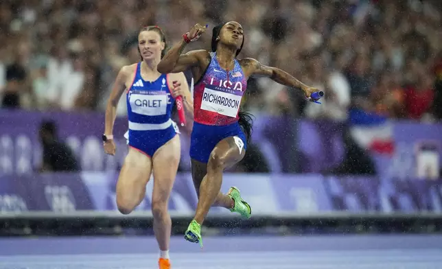 FILE - Sha'carri Richardson, of the U.S., crosses the finish line to win the women's 4 x 100 meters relay final at the Summer Olympic Games in Saint-Denis, France, Aug. 9, 2024. (AP Photo/Ashley Landis, File)