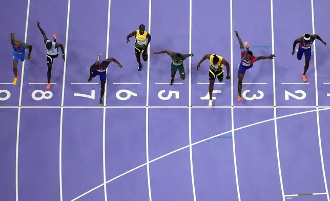 FILE - Noah Lyles, of the United States, in lane seven, wins the men's 100-meter final at the 2024 Summer Olympics, Sunday, Aug. 4, 2024, in Saint-Denis, France. (AP Photo/David J. Phillip, File)