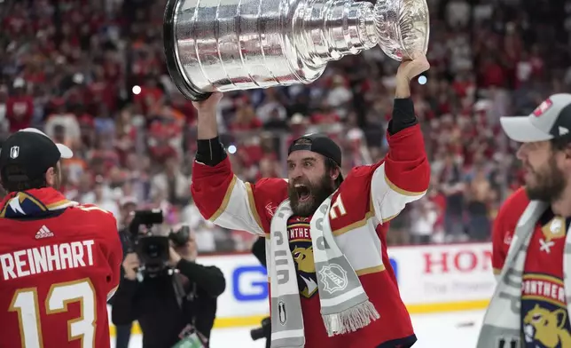 FILE - Florida Panthers defenseman Aaron Ekblad raises the NHL hockey Stanley Cup trophy after defeating the Edmonton Oilers in Game 7 of the Final, Monday, June 24, 2024, in Sunrise, Fla. (AP Photo/Wilfredo Lee, File)