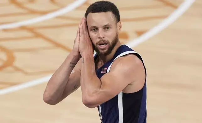 FILE - United States' Stephen Curry (4) reacts after a three-point basket against France in the men's gold medal basketball game at the 2024 Summer Olympics, Saturday, Aug. 10, 2024 in Paris, France. (AP Photo/Michael Conroy, File)