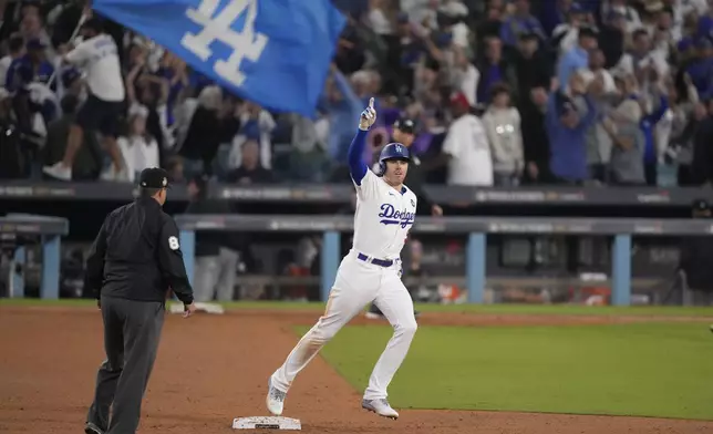 FILE - Los Angeles Dodgers' Freddie Freeman celebrates after hitting a walk-off grand slam home run during the 10th inning in Game 1 of the baseball World Series against the New York Yankees, Friday, Oct. 25, 2024, in Los Angeles. (AP Photo/Mark J. Terrill, File)