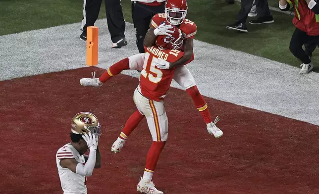 FILE - Kansas City Chiefs wide receiver Mecole Hardman Jr. (12) celebrates with Patrick Mahomes (15) after scoring the game winning touchdown in overtime as San Francisco 49ers place kicker Jake Moody (4) walks off the field during the NFL Super Bowl 58 football game Sunday, Feb. 11, 2024, in Las Vegas.(AP Photo/Adam Hunger, File)