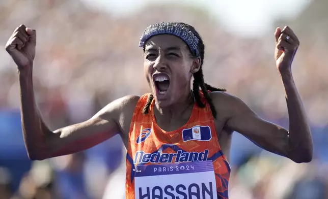 FILE - Sifan Hassan, of the Netherlands, celebrates after crossing the finish line to win the gold medal at the end of the women's marathon competition at the 2024 Summer Olympics, Sunday, Aug. 11, 2024, in Paris, France. (AP Photo/Vadim Ghirda, File)