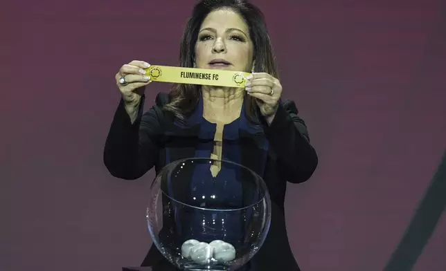 Gloria Estefan displays Fluminense Football Club during the draw for the 2025 FIFA Club World Cup soccer tournament, Thursday, Dec. 5, 2024, in Miami. (AP Photo/Rebecca Blackwell)