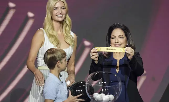 Ivanka Trump and her son Theodore help with the draw with Gloria Estefan pulls Sociedade Esportiva Palmeiras out of a bowl during the draw for the 2025 FIFA Club World Cup soccer tournament, Thursday, Dec. 5, 2024, in Miami. (AP Photo/Rebecca Blackwell)