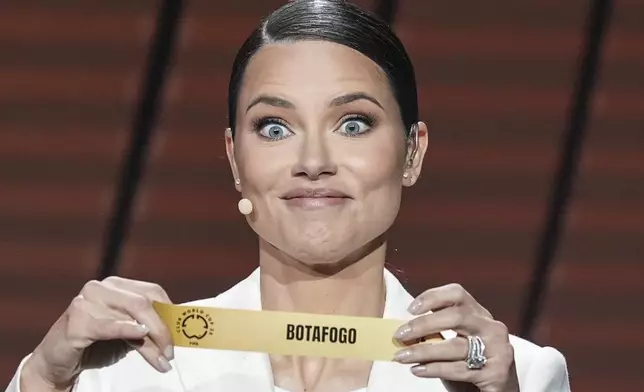 Adriana Lima displays Botafogo during the fourth draw for the 2025 FIFA Club World Cup soccer tournament, Thursday, Dec. 5, 2024, in Miami. (AP Photo/Rebecca Blackwell)