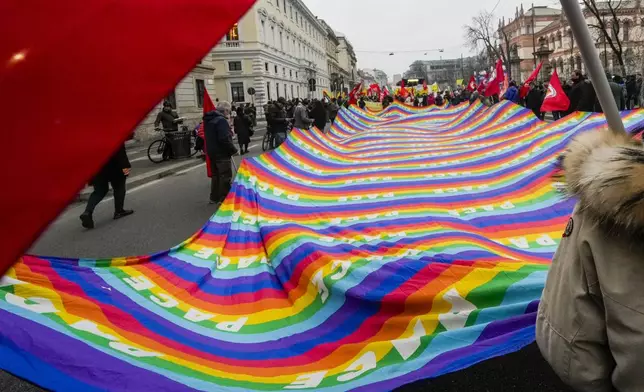 People take to the street in MIlan, Saturday, Dec. 7, 2024, to protest against ongoing wars and a security bill being discussed in the parliament that would introduce new rules about public demonstrations and the right to strike. (AP Photo/Luca Bruno)