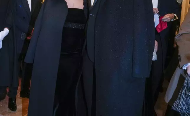 Olympic medallist Gianmarco Tamberi and wife Chiara Bontempi, left, pose for photographers as they arrive at Milan's Opera House La Scala, northern Italy, for the opening of the 2024-25 season featuring Giuseppe Verdi's 'La Forza del destino', Saturday, Dec. 7, 2024. (AP Photo/Luca Bruno)
