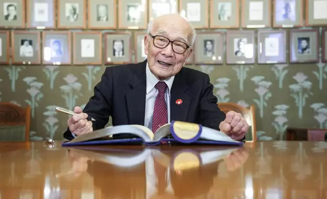 Representative of this year's Nobel Peace Prize winner Nihon Hidankyo, or the Japan Confederation of A- and H-Bomb Sufferers Organizations, Terumi Tanaka signs the guest book ahead of the Nobel Peace Prize ceremony, at the Nobel Institute in Oslo, on Monday, Dec. 9, 2024. (Javad Parsa/NTB Scanpix via AP)