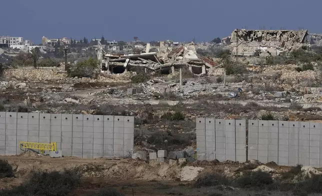 Destroyed buildings in the area of a village in Southern Lebanon located next to the Israeli-Lebanese border, as seen from northern Israel, Friday, Dec. 6, 2024. (AP Photo/Matias Delacroix)