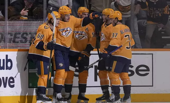 Nashville Predators defenseman Brady Skjei (76) celebrates his goal with teammates during the third period of an NHL hockey game against the Pittsburgh Penguins, Thursday, Dec. 19, 2024, in Nashville, Tenn. (AP Photo/George Walker IV)