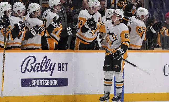 Pittsburgh Penguins right wing Rickard Rakell (67) celebrates his goal with teammates during the second period of an NHL hockey game against the Nashville Predators, Thursday, Dec. 19, 2024, in Nashville, Tenn. (AP Photo/George Walker IV)