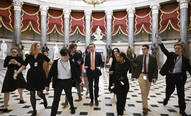 Rep. Dusty Johnson, R-S.D., talks with reporters after attending a meeting with Speaker of the House Mike Johnson, R-La., as the House works on a spending bill to avert a shutdown of the Federal Government, Friday, Dec. 20, 2024, at the Capitol in Washington. (AP Photo/John McDonnell)