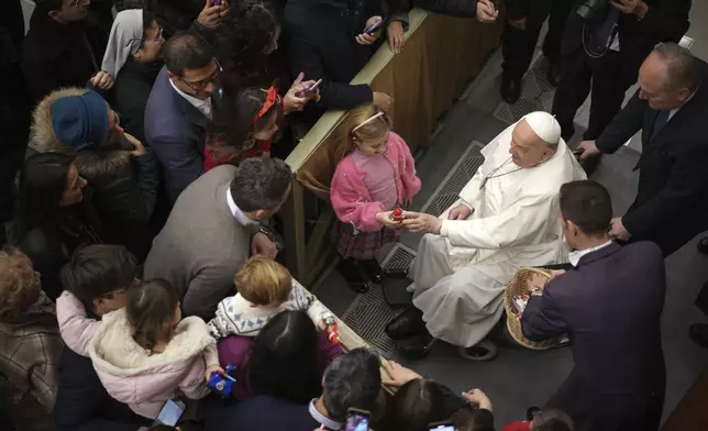 Pope Francis exchanges season greetings with Vatican employees, in the Paul VI Hall at the Vatican, Saturday, Dec. 21, 2024. (AP Photo/Andrew Medichini)