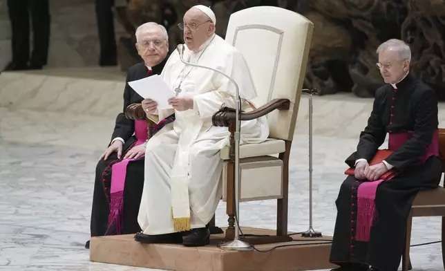 Pope Francis exchanges the season's greetings with Vatican employees, in the Paul VI Hall at the Vatican, Saturday, Dec. 21, 2024. (AP Photo/Andrew Medichini)