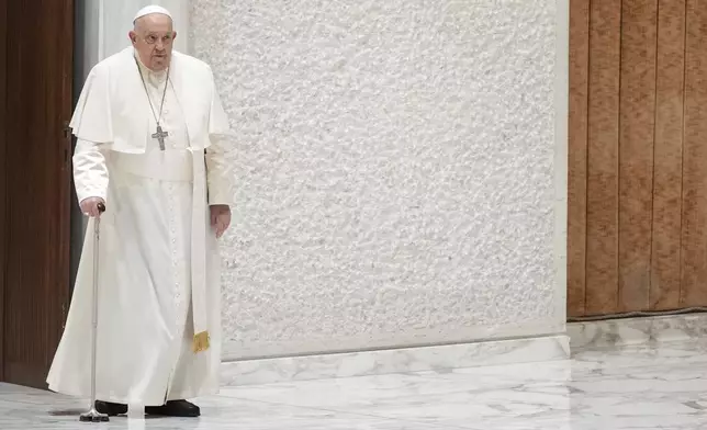 Pope Francis arrives to exchange the season's greetings with Vatican employees, in the Paul VI Hall at the Vatican, Saturday, Dec. 21, 2024. (AP Photo/Andrew Medichini)