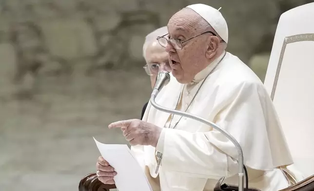 Pope Francis exchanges the season's greetings with Vatican employees, in the Paul VI Hall at the Vatican, Saturday, Dec. 21, 2024. (AP Photo/Andrew Medichini)