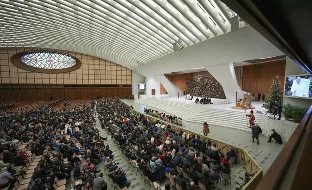 Pope Francis exchanges the season's greetings with Vatican employees, in the Paul VI Hall at the Vatican, Saturday, Dec. 21, 2024. (AP Photo/Andrew Medichini)