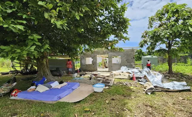 In this photo released by Vanuatu Red Cross Society, bedding lies outside a damaged house in Efate, Vanuatu, Thursday, Dec. 19, 2024, following a powerful earthquake that struck just off the coast of Vanuatu in the South Pacific Ocean. (Vanuatu Red Cross Society via AP)