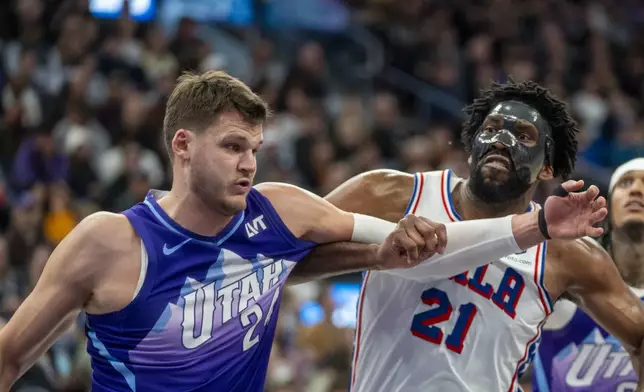 Utah Jazz center Walker Kessler (24) jockeys for position with Philadelphia 76ers center Joel Embiid (21) during the first half of an NBA basketball game Saturday, Dec. 28, 2024, in Salt Lake City. (AP Photo/Rick Egan)