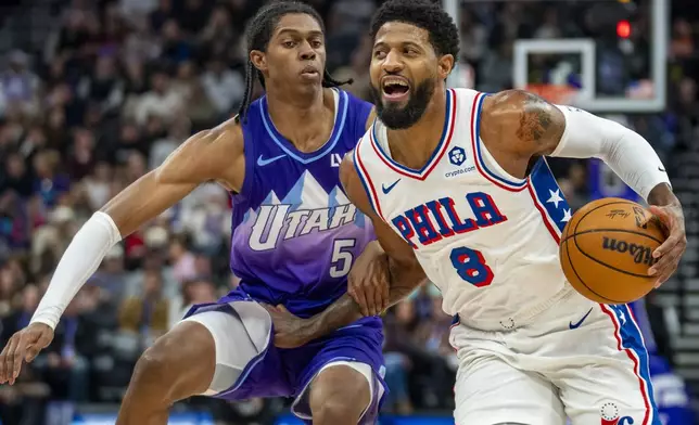 Philadelphia 76ers forward Paul George (8) breaks for the basket as Utah Jazz forward Cody Williams (5) defends during the first half of an NBA basketball game Saturday, Dec. 28, 2024, in Salt Lake City. (AP Photo/Rick Egan)