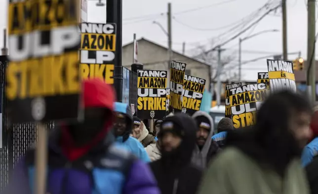 Amazon workers and members of the International Brotherhood of Teamsters picket in front of the Amazon fulfilment center in the Queens borough of in New York, on Friday, Dec. 20, 2024. (AP Photo/Stefan Jeremiah)