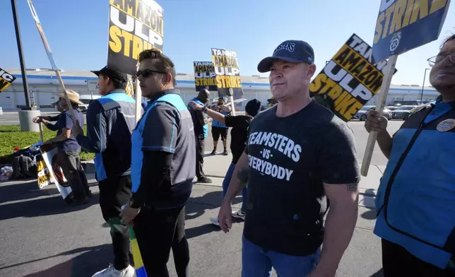 Sean O'Brien, General president of the International Brotherhood of Teamsters joins other Amazon workers during a strike outside the gates of an Amazon Fulfillment Center Friday, Dec. 20, 2024, in City of Industry, Calif. (AP Photo/Damian Dovarganes)